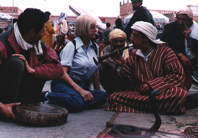 American traveler, Marjory Day with snake charmer, Blaid Farrouss at the public square of Marrakech