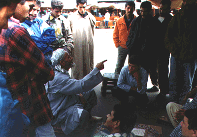 A storyteller teaches from the Koran in early morning.